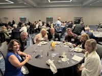 a group of people sitting around a table