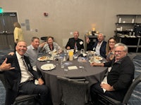 a group of people posing for a picture at a table