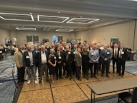 a group of people posing for a picture in a conference room