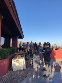 a group of people standing around a table