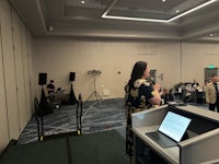 a woman giving a presentation in a conference room