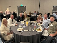 a group of people posing for a photo at a banquet