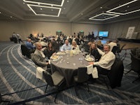 a group of people sitting around a table in a conference room