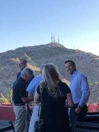 a group of people standing near a mountain